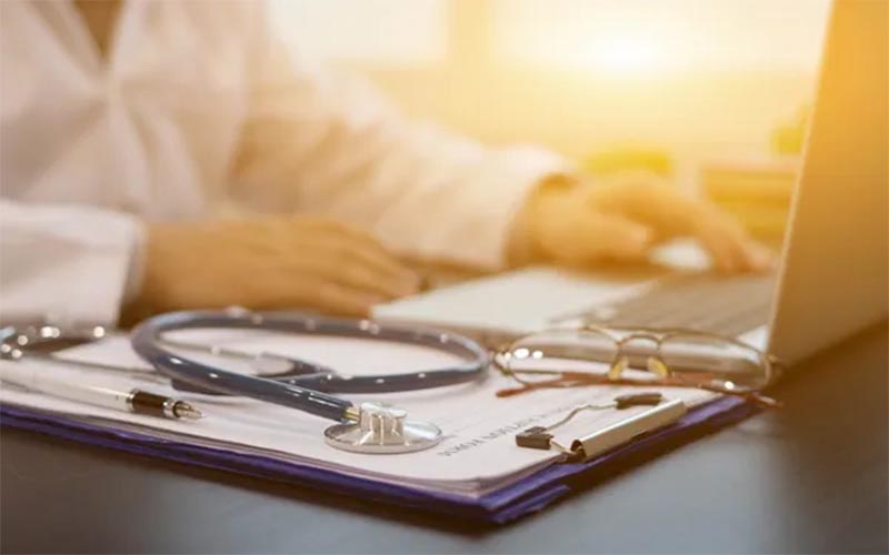 Doctor's desk with a stethoscope and laptop